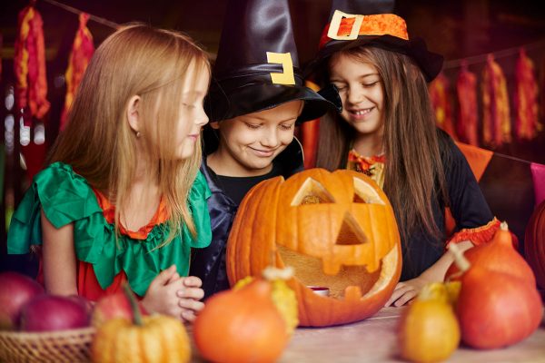 group-of-children-carving-pumpkins