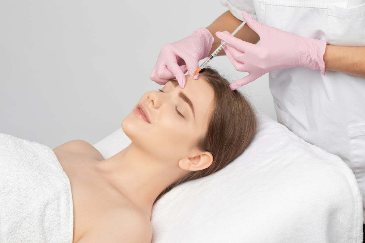 Woman Getting BOTOX Injection in Forehead
