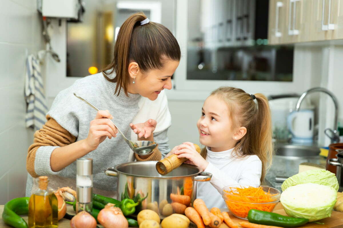 Mother and Daughter Cooking a Healthy Meal Inspired by the New USDA Nutrition Guidelines 