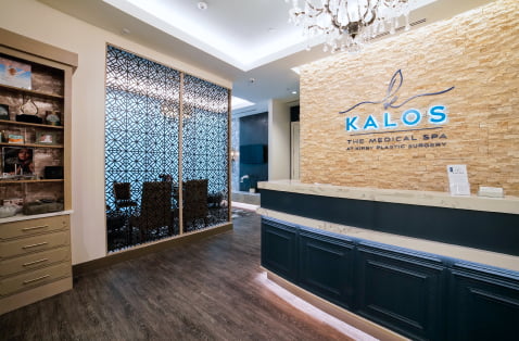 An inviting, well-lit Kalos Medical Spa reception desk, located within Kirby Plastic Surgery.