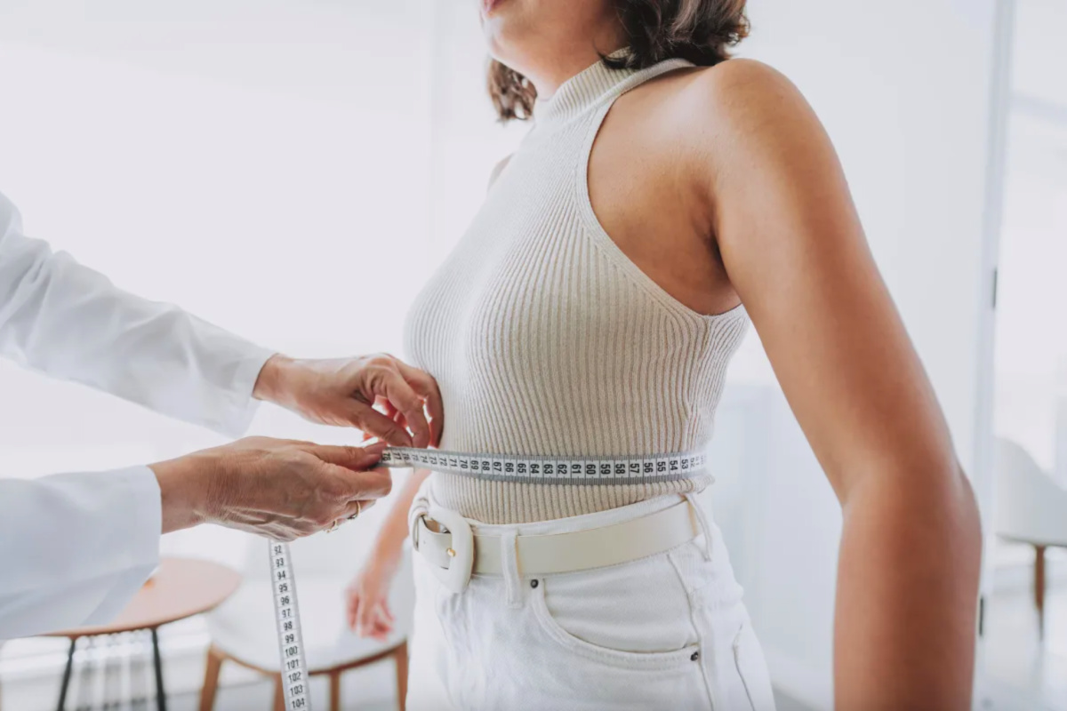 Faceless woman getting her measurements taken at a Fort Worth medical weight loss program check in appointment